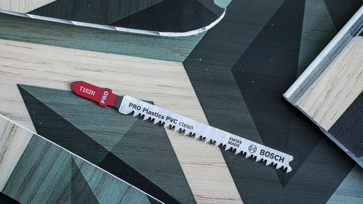 Object #200469109: 3066410_app_web_2 Jigsaw blade for cutting plastic and laminate panels on a patterned work surface.